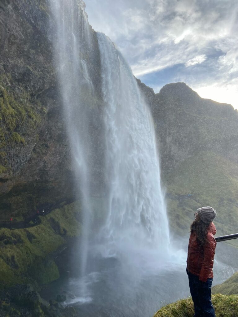 Claudia looking at Seljalandsfoss and the hike behind it on Apogee's Iceland Mountains and Coast trip. 
