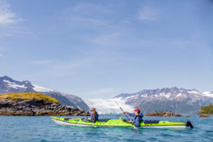 Teen adventure summer camp kayaking through Alaska Mountains and Coast