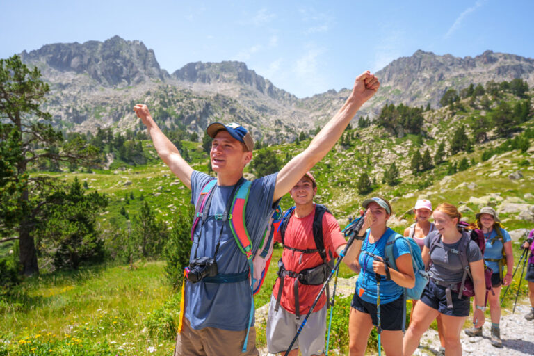 teens hiking and celebrating in pyrenees mountains